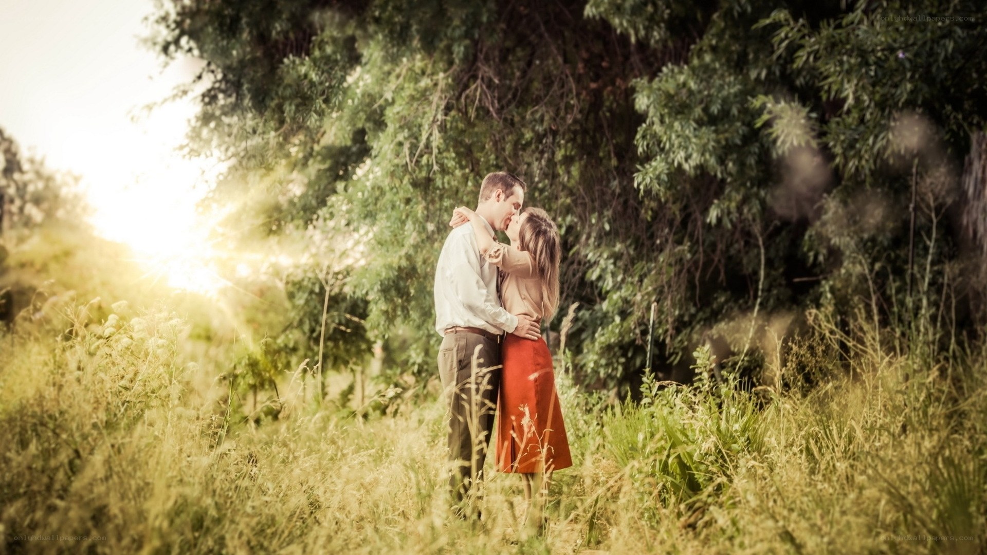 Couple embracing in a field