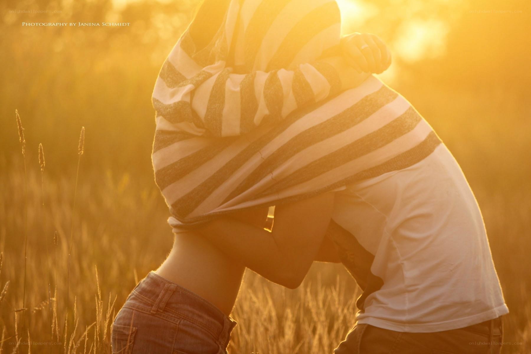 Couple embracing in golden field
