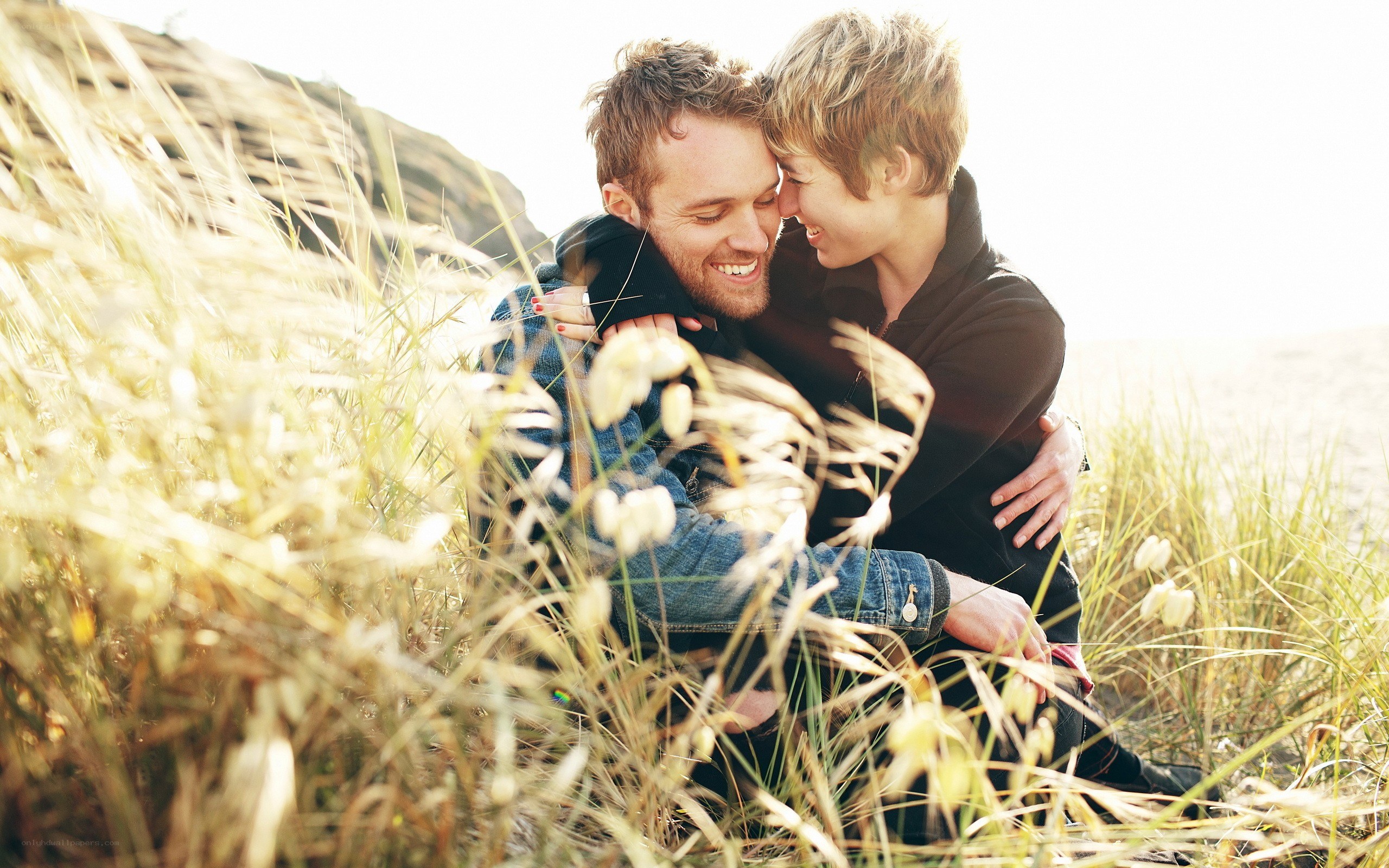 Couple embracing in grass
