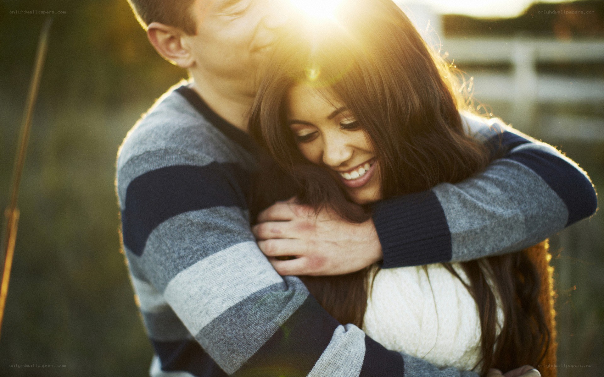 Couple embracing in sunlight