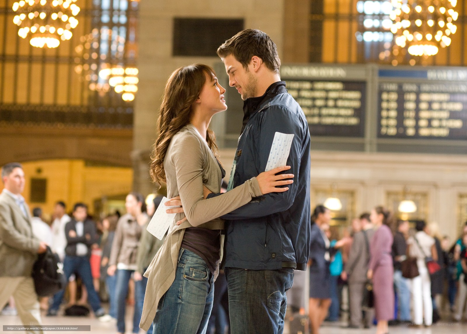couple embracing in train station