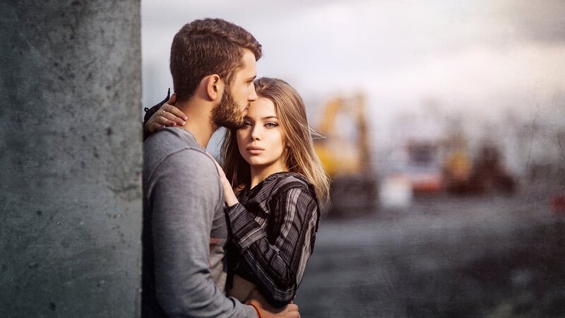 Couple Embracing Near Concrete