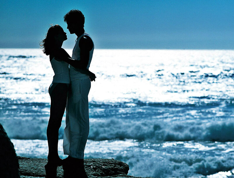 Couple Embracing on Beach — Blue, Romantic, Sunset, Photograph