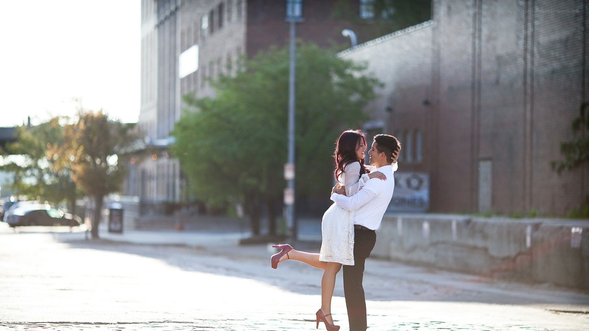 Couple embracing on city street