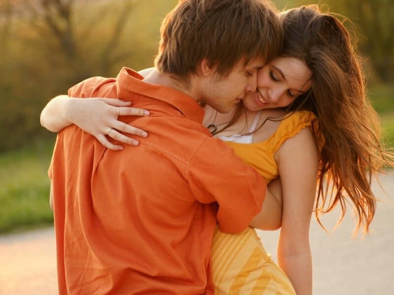 Couple Embracing Outdoors — Orange