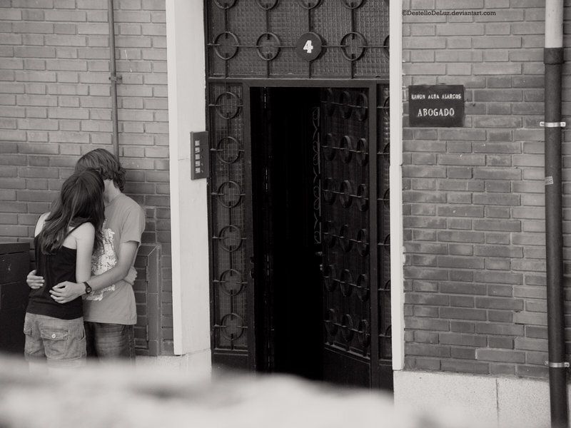 Couple Embracing Outside Door