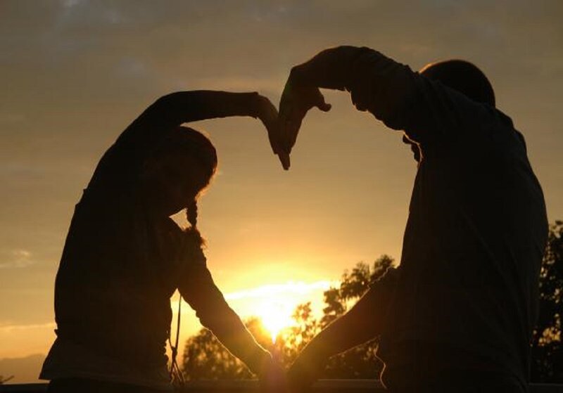 Couple Forming Heart Shape — Orange
