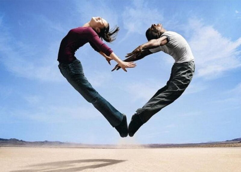 couple forming heart shape