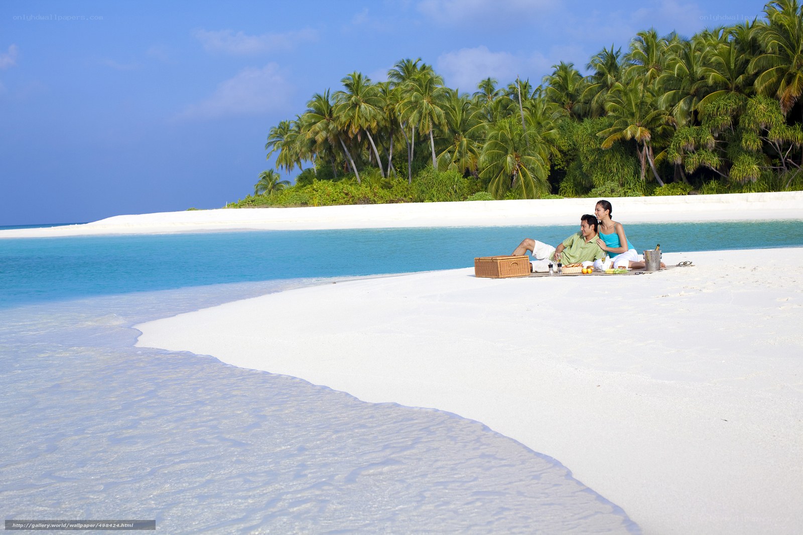 Couple having picnic on tropical beach