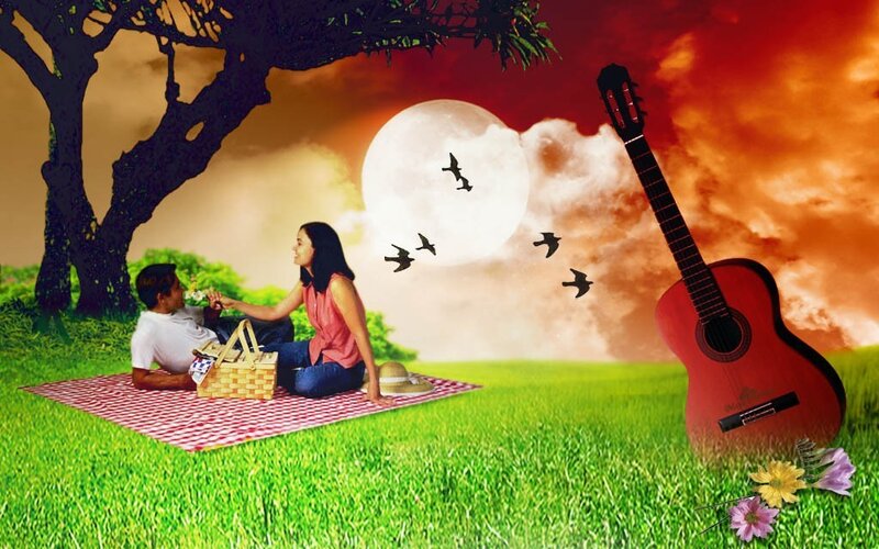 Couple having picnic under moon