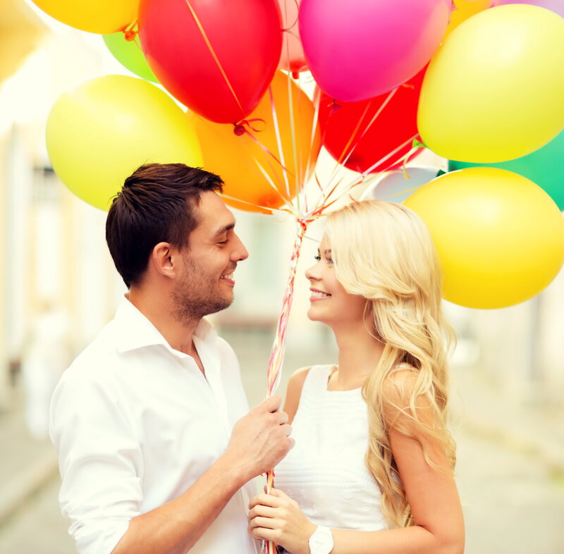 Couple Holding Balloons