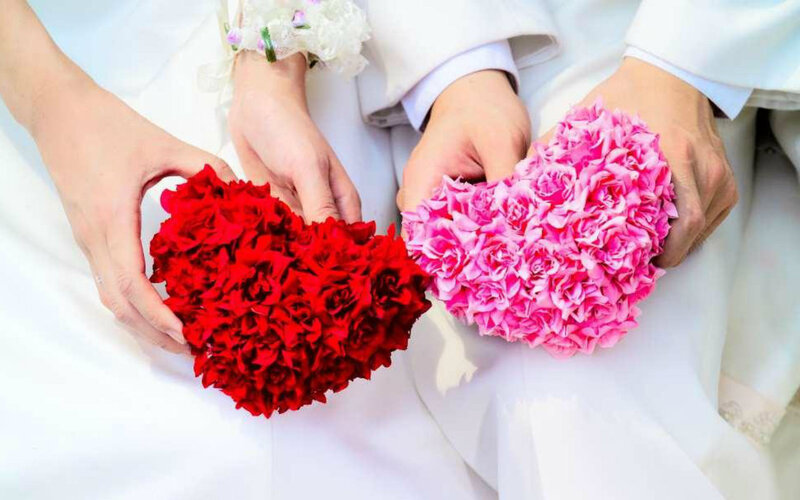Couple Holding Flower Hearts
