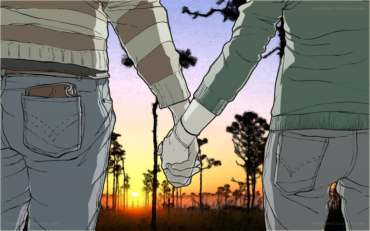 Couple holding hands at sunset