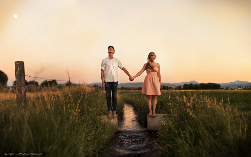 Couple holding hands at sunset