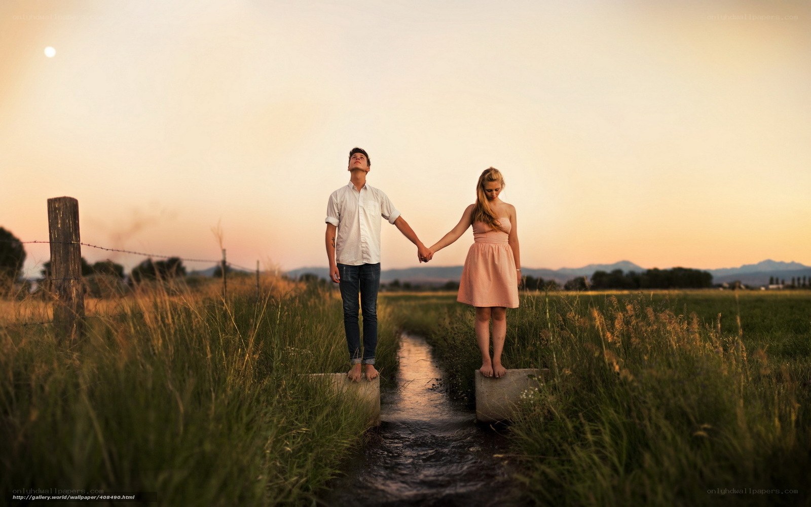 Couple holding hands at sunset