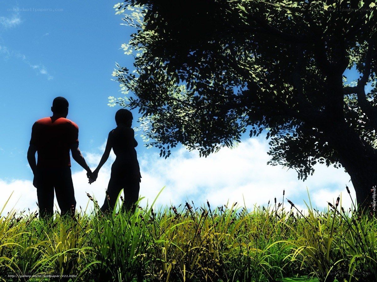 Couple holding hands in a field