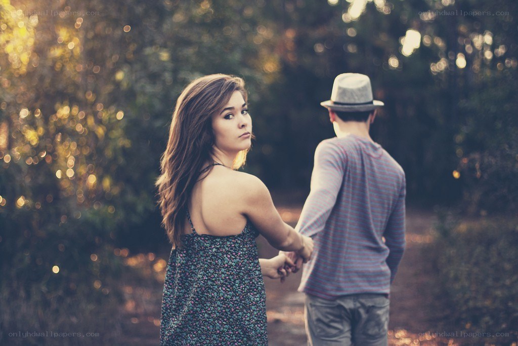 couple holding hands in park