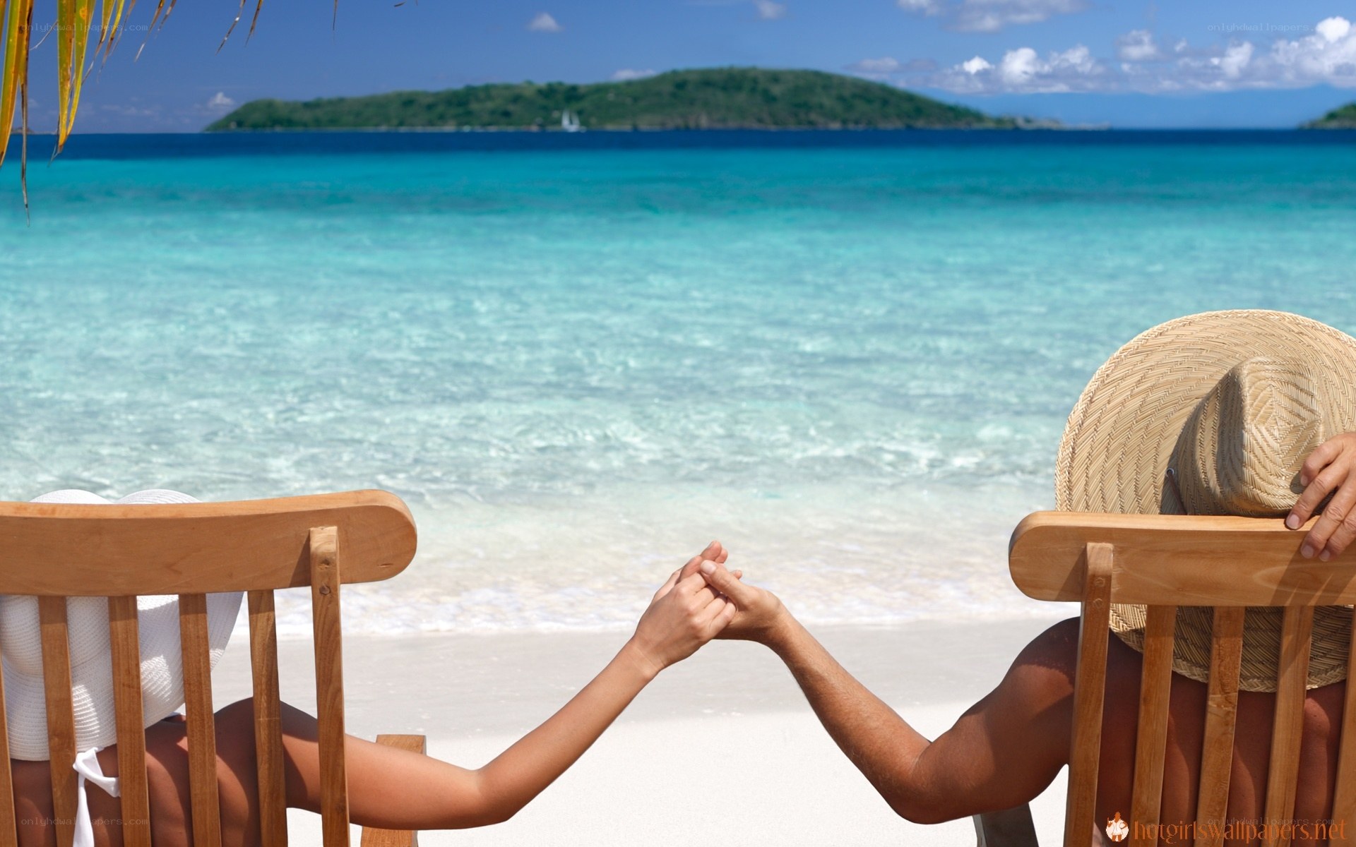 Couple holding hands on beach