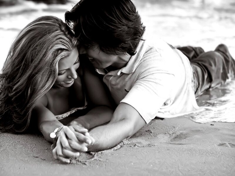 Couple holding hands on beach