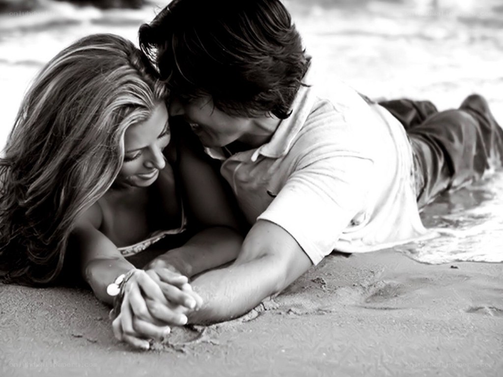 Couple holding hands on beach