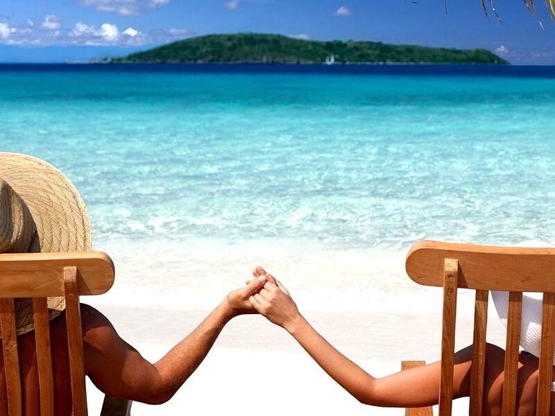 Couple holding hands on beach