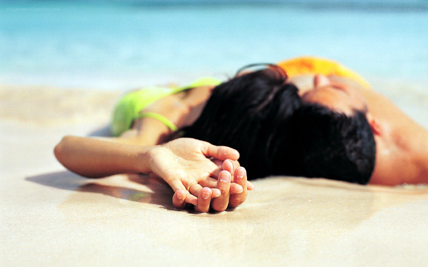 Couple holding hands on beach