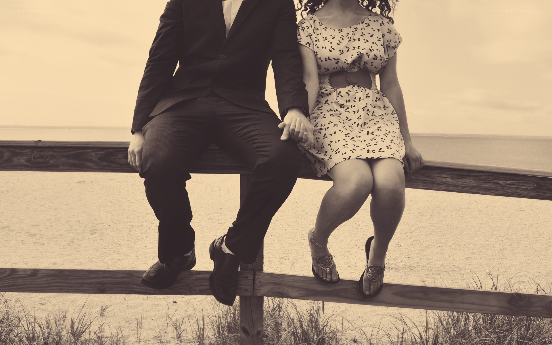 Couple holding hands on beach