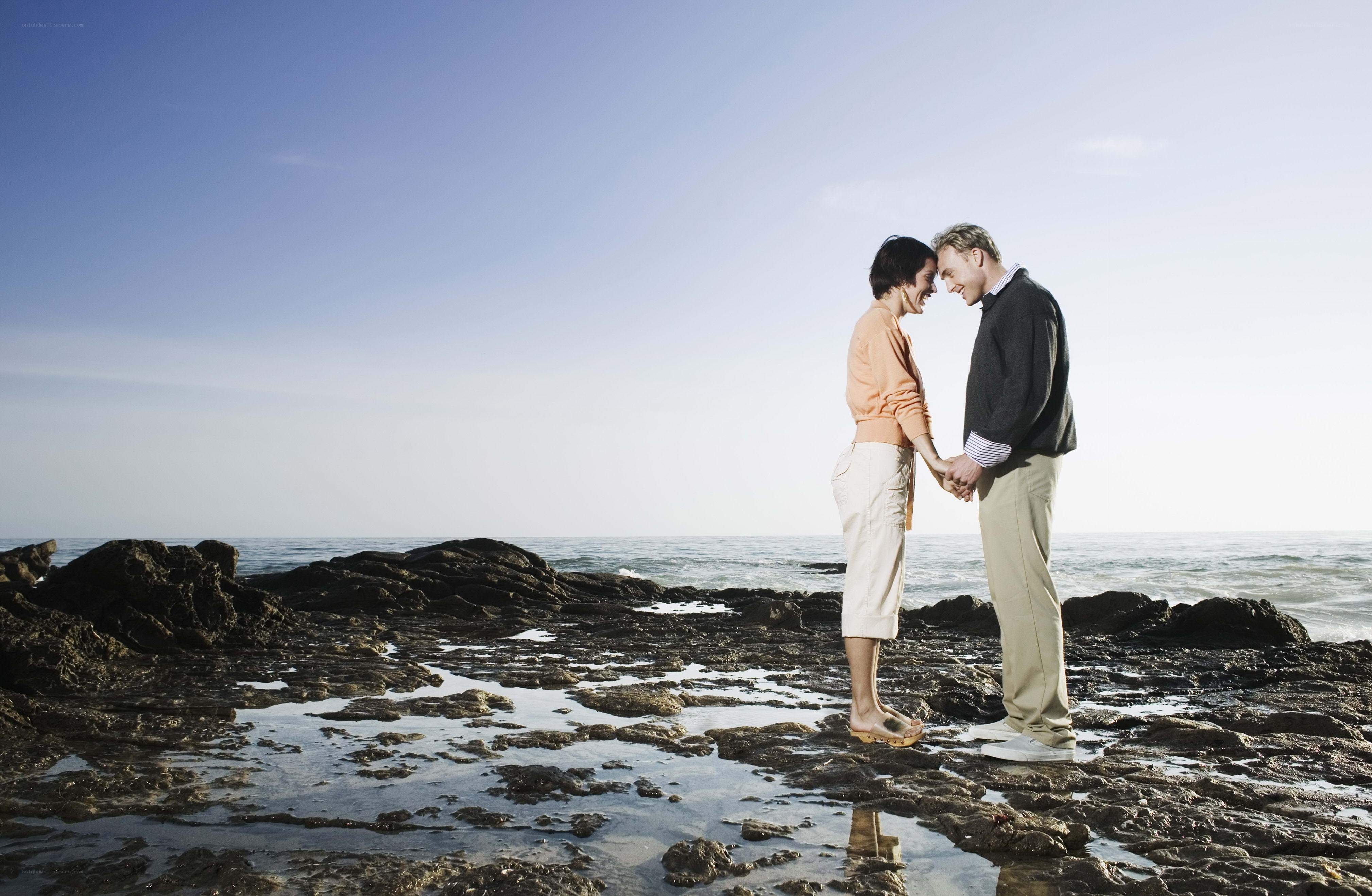 Couple holding hands on beach