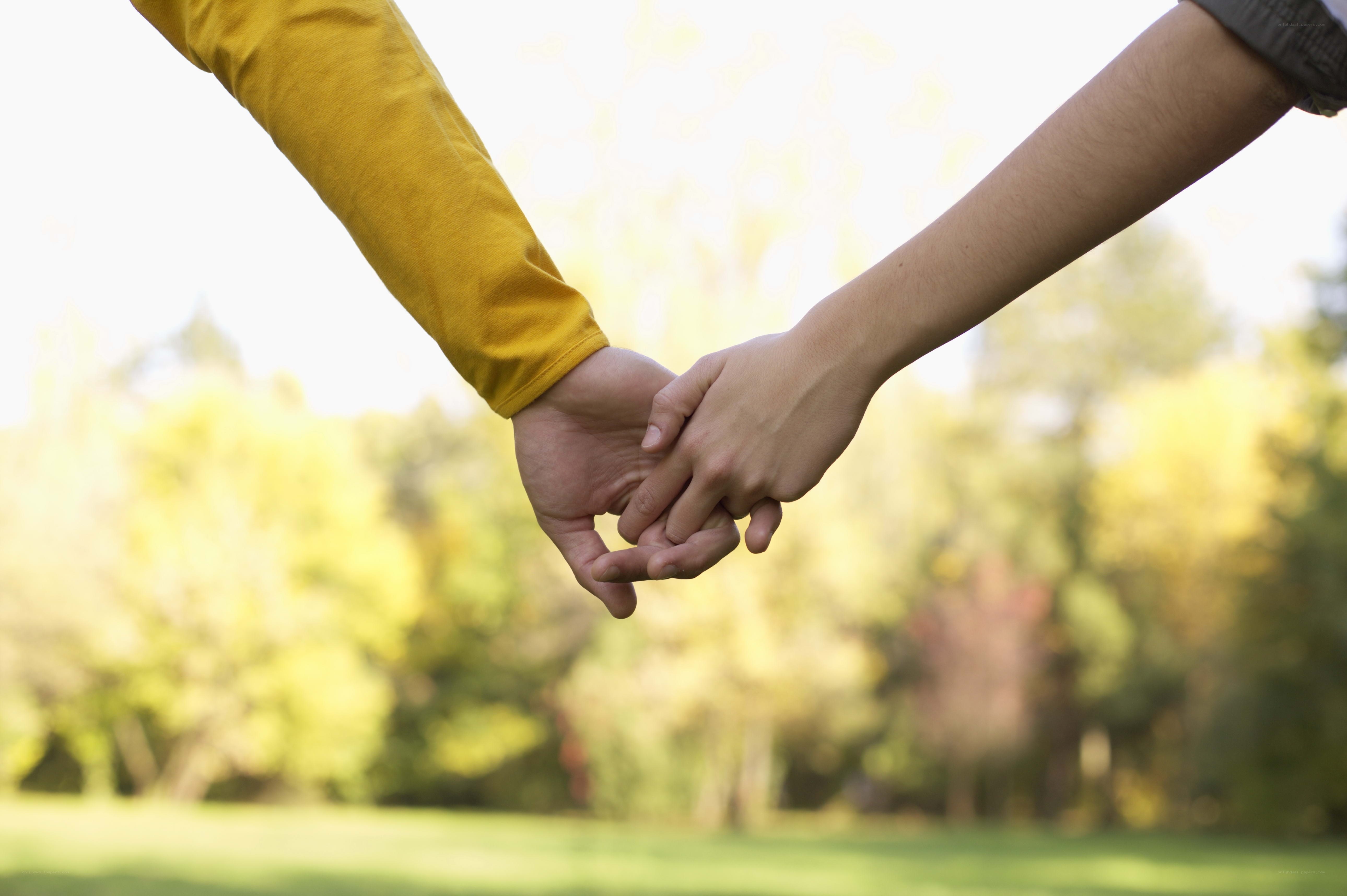 Couple holding hands outdoors