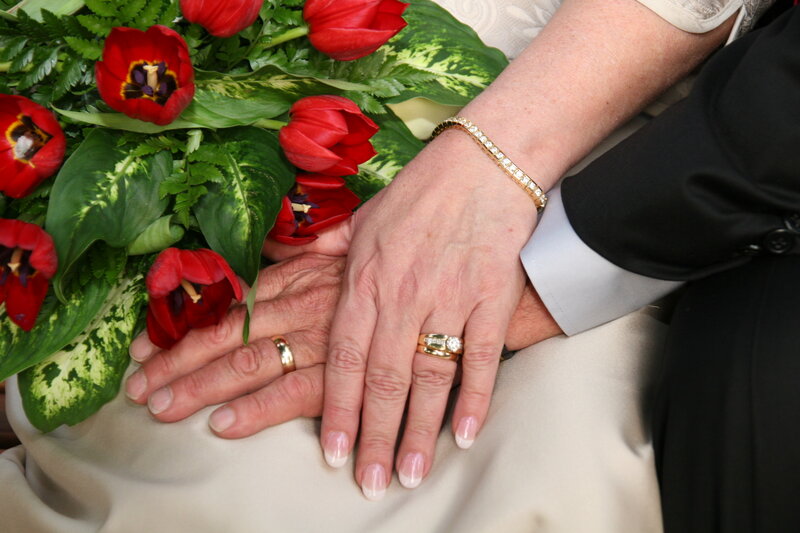 Couple holding hands with flowers