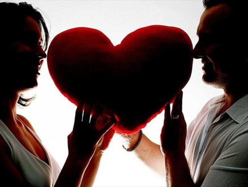 Couple Holding Heart Pillow