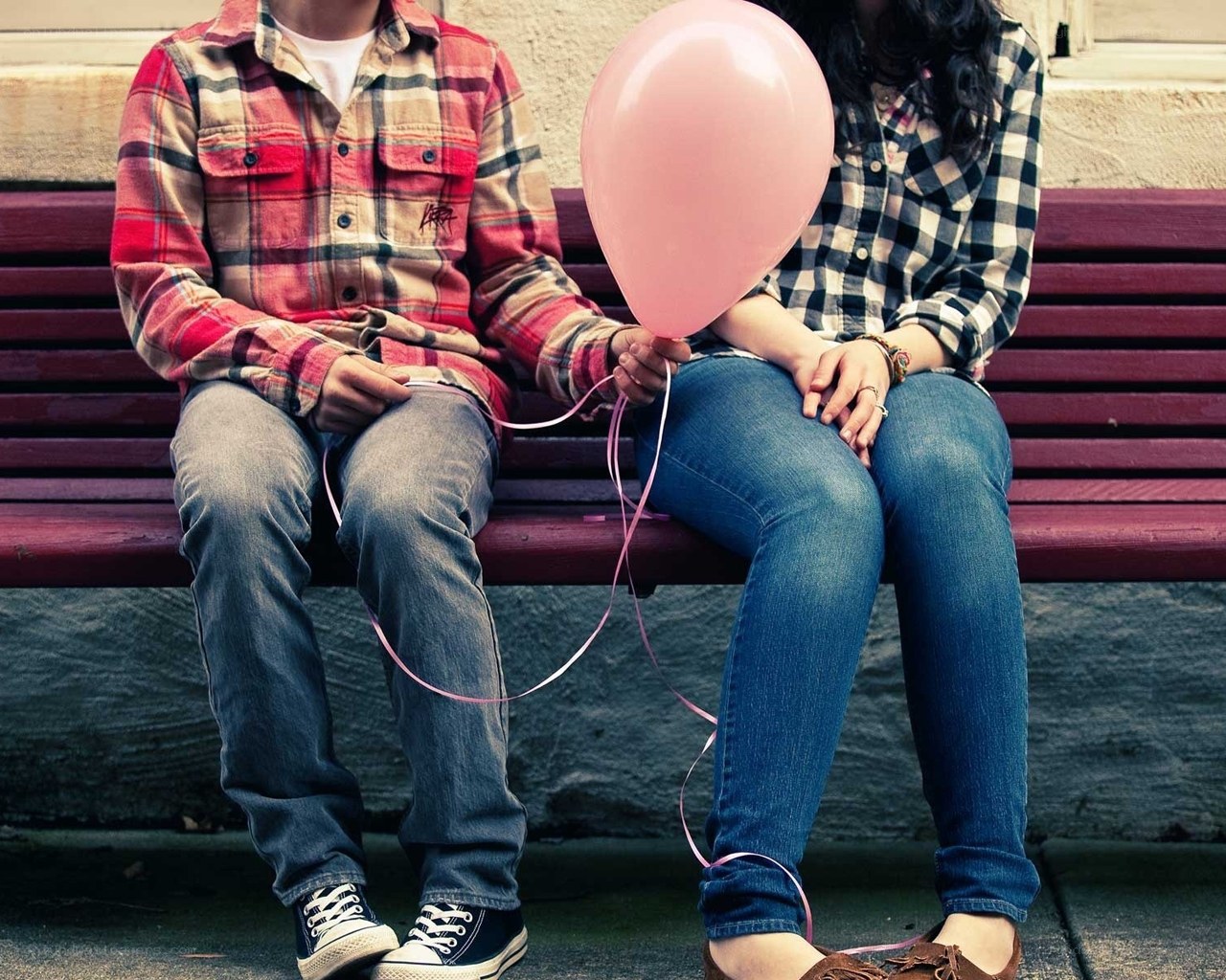 Couple holding pink balloon