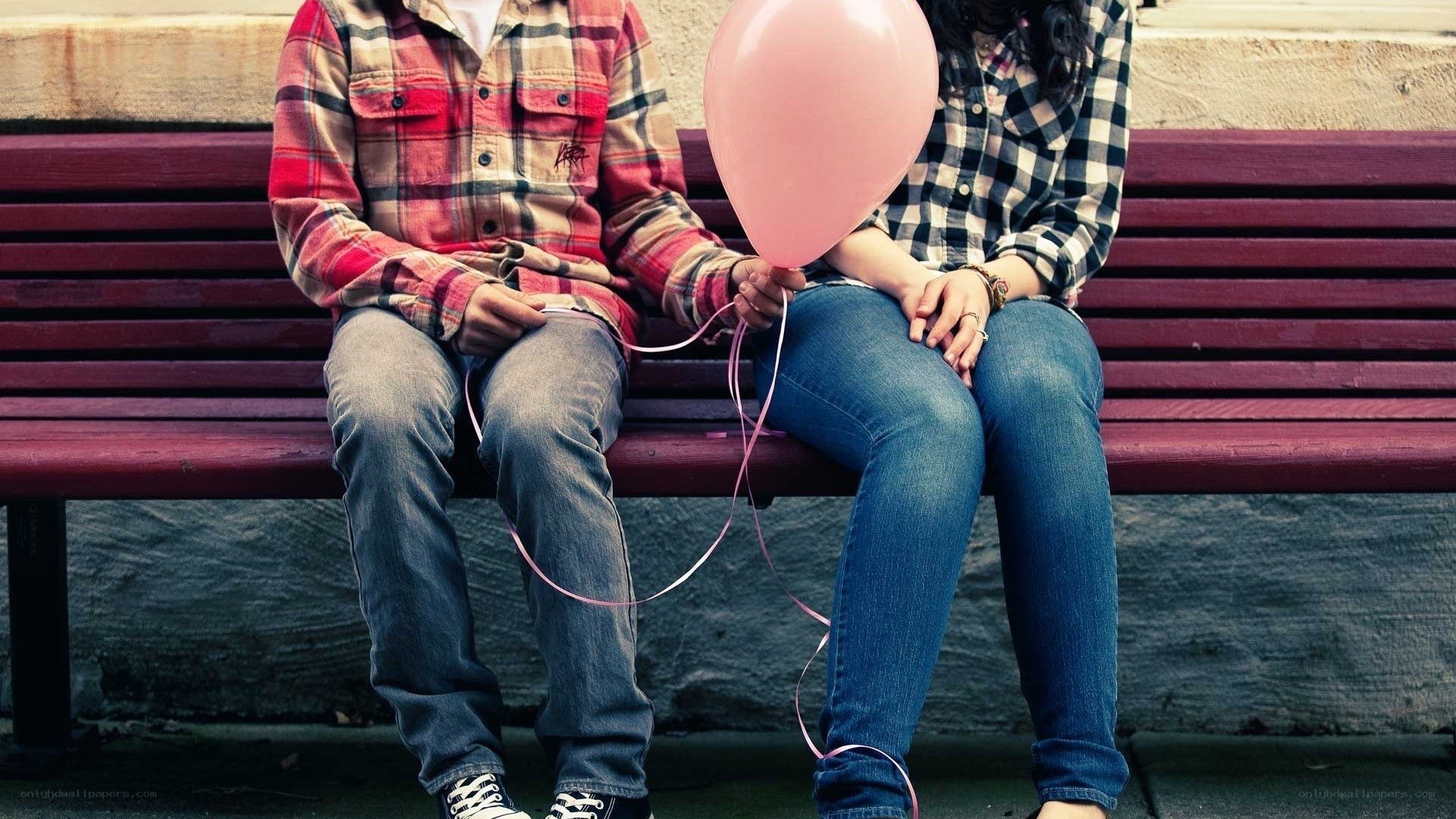 Couple holding pink balloon