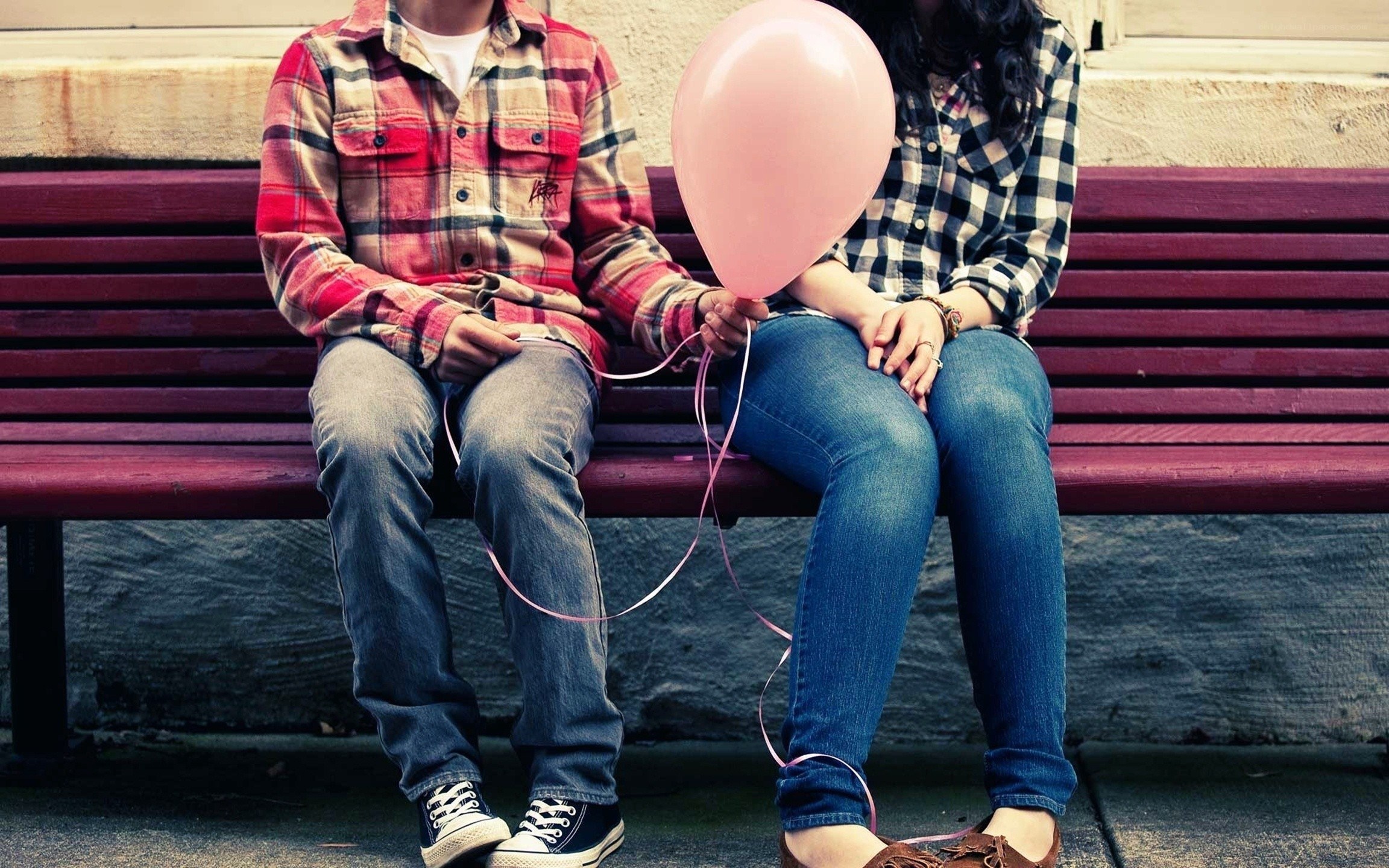 Couple holding pink balloon