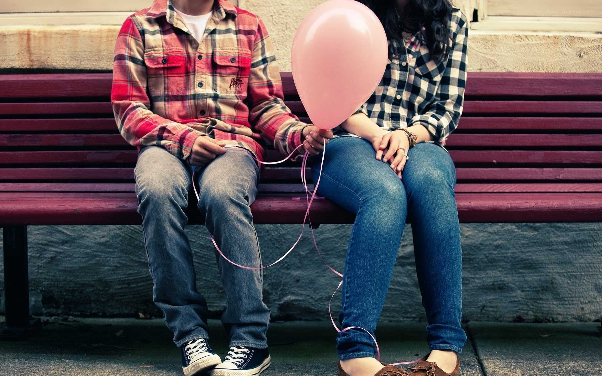 Couple holding pink balloon