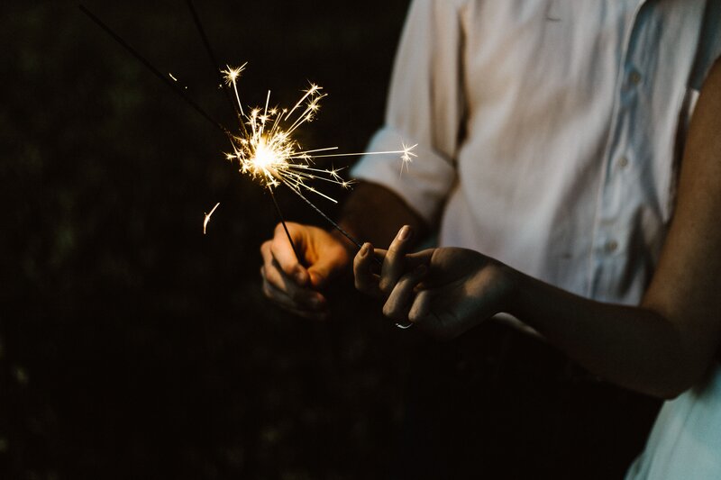 Couple holding sparklers at night