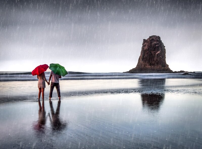 Couple Holding Umbrellas