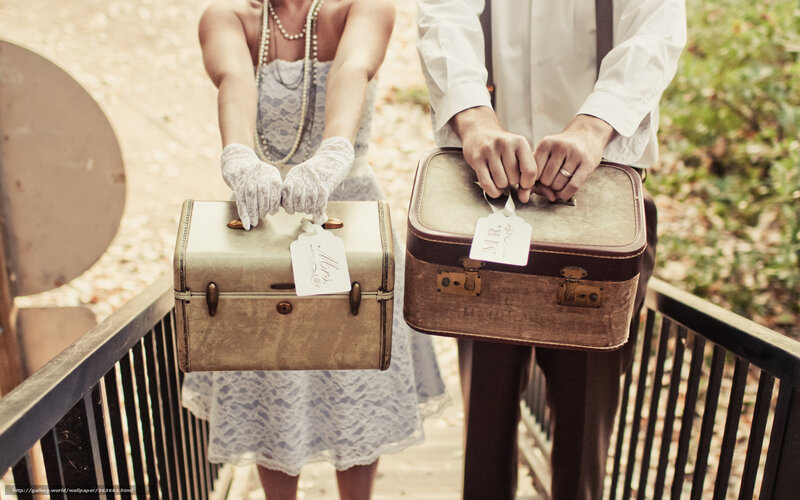 Couple holding vintage suitcases