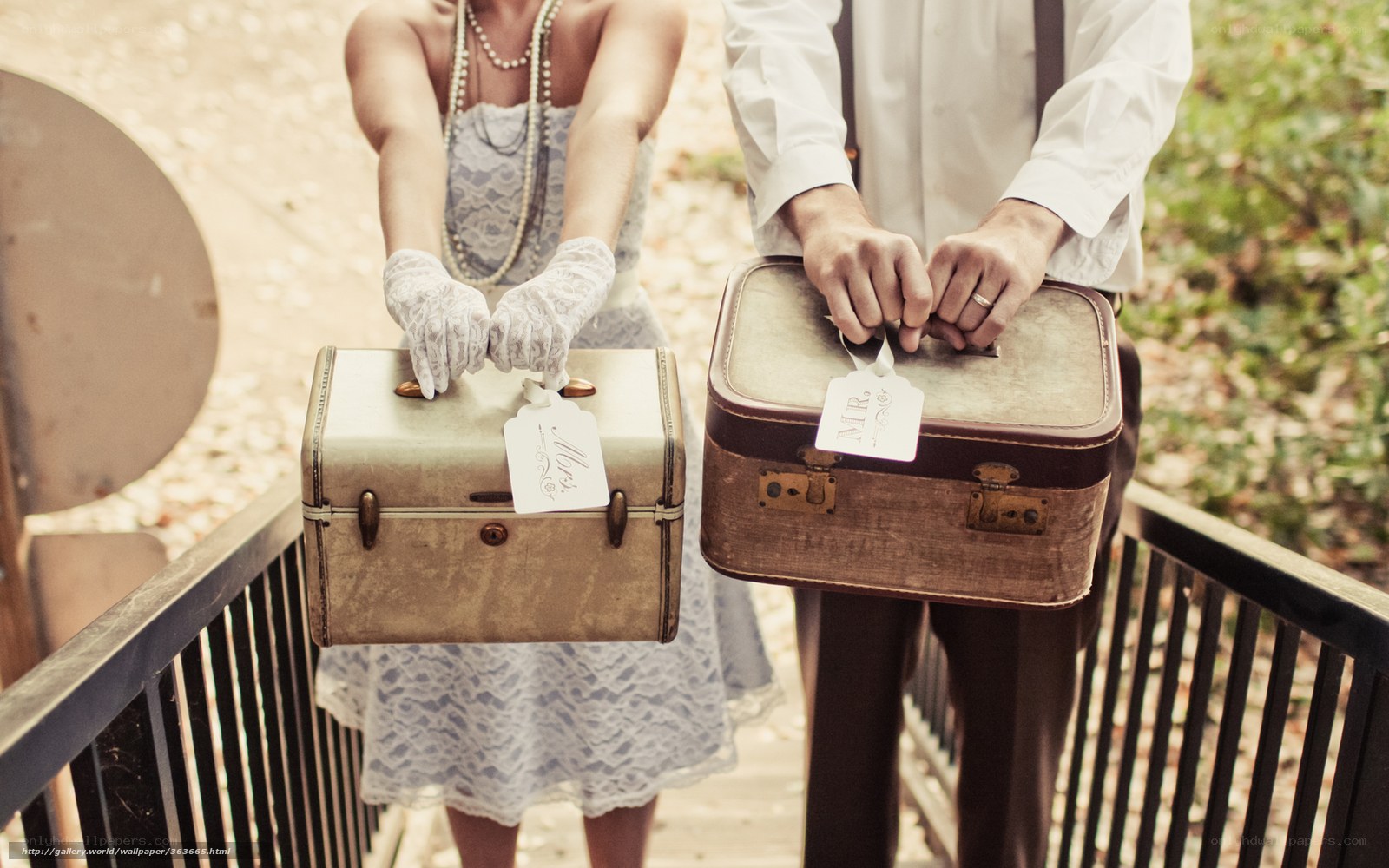 Couple holding vintage suitcases