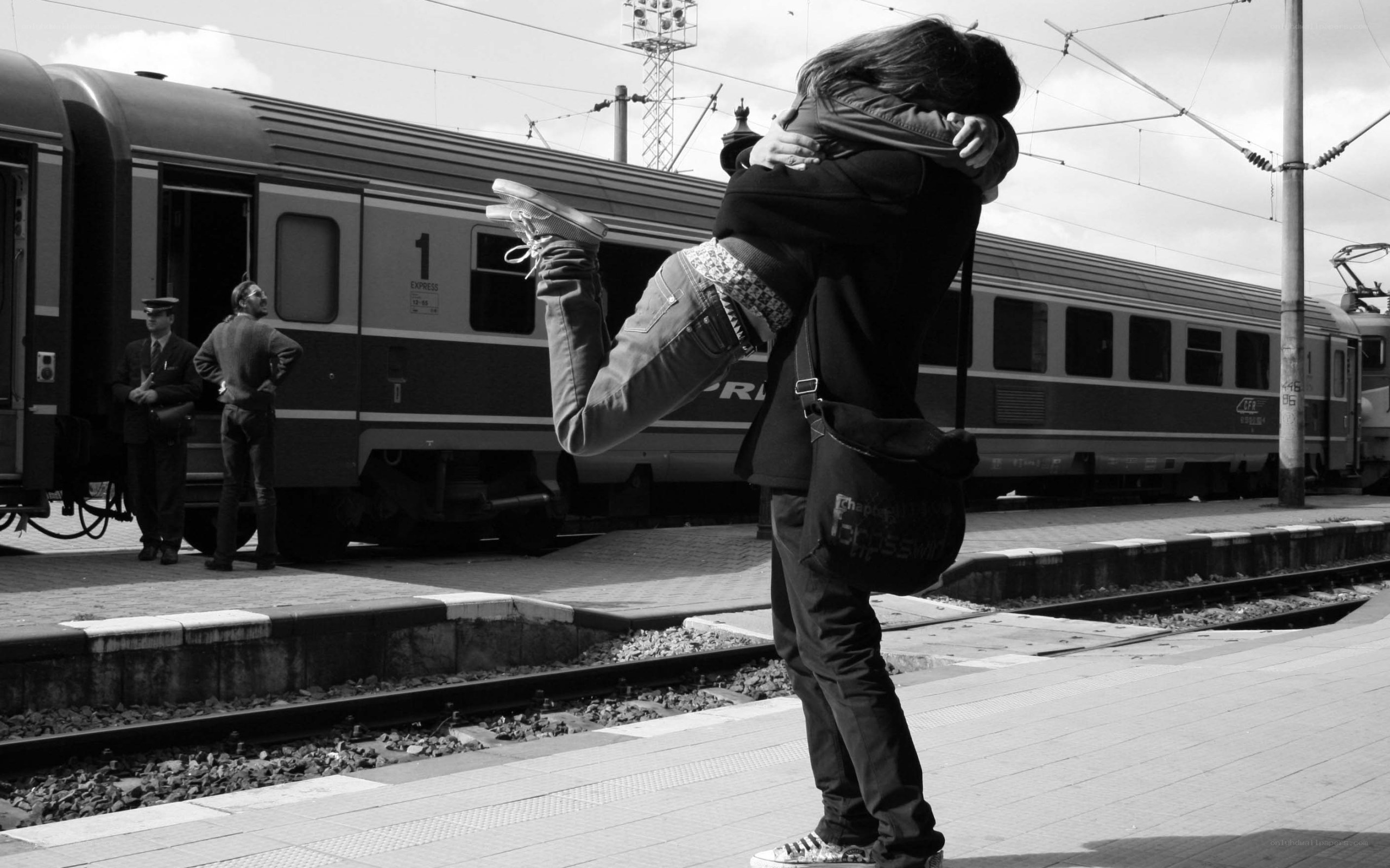 Couple hugging at train station