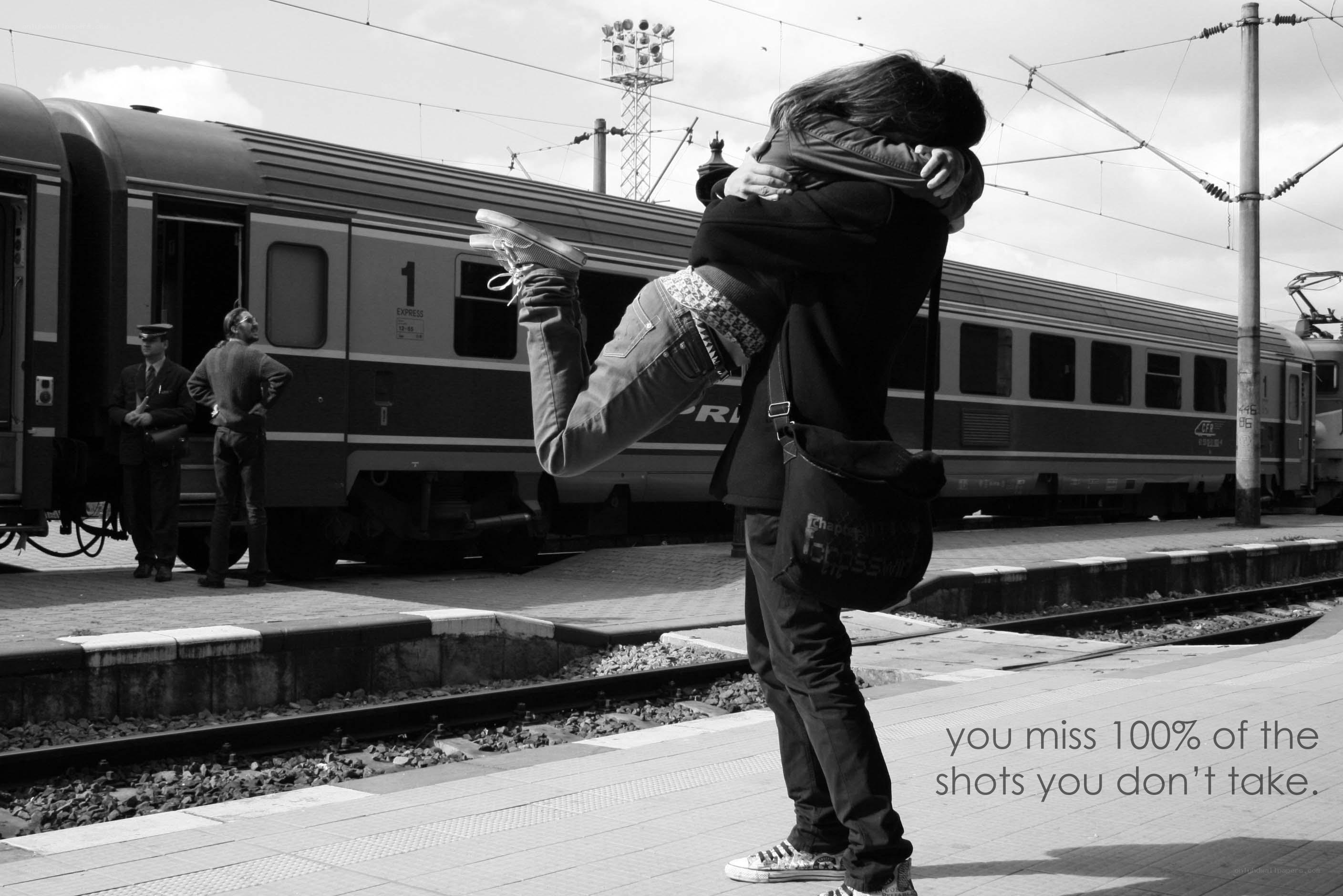 couple hugging at train station