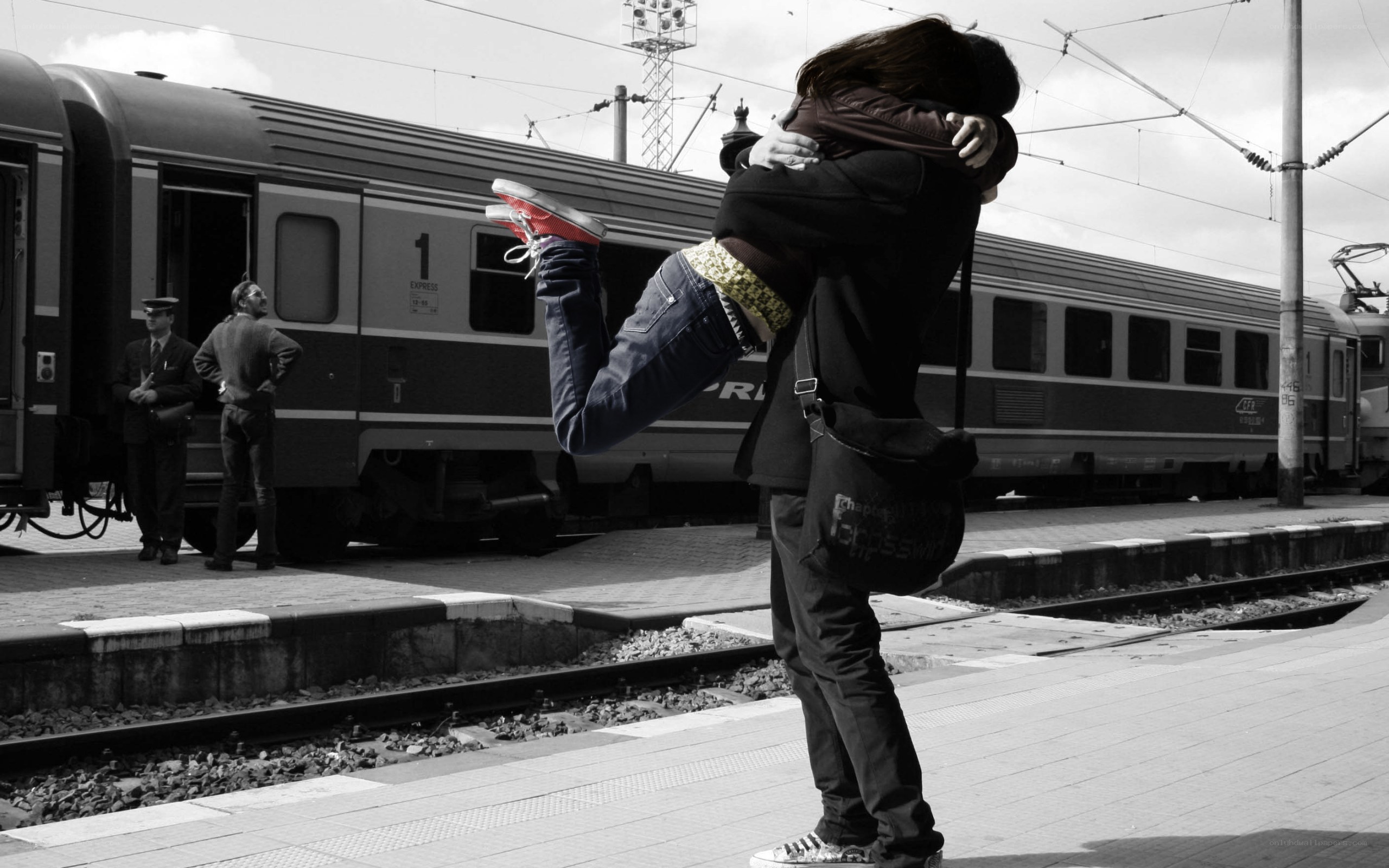 Couple hugging at train station