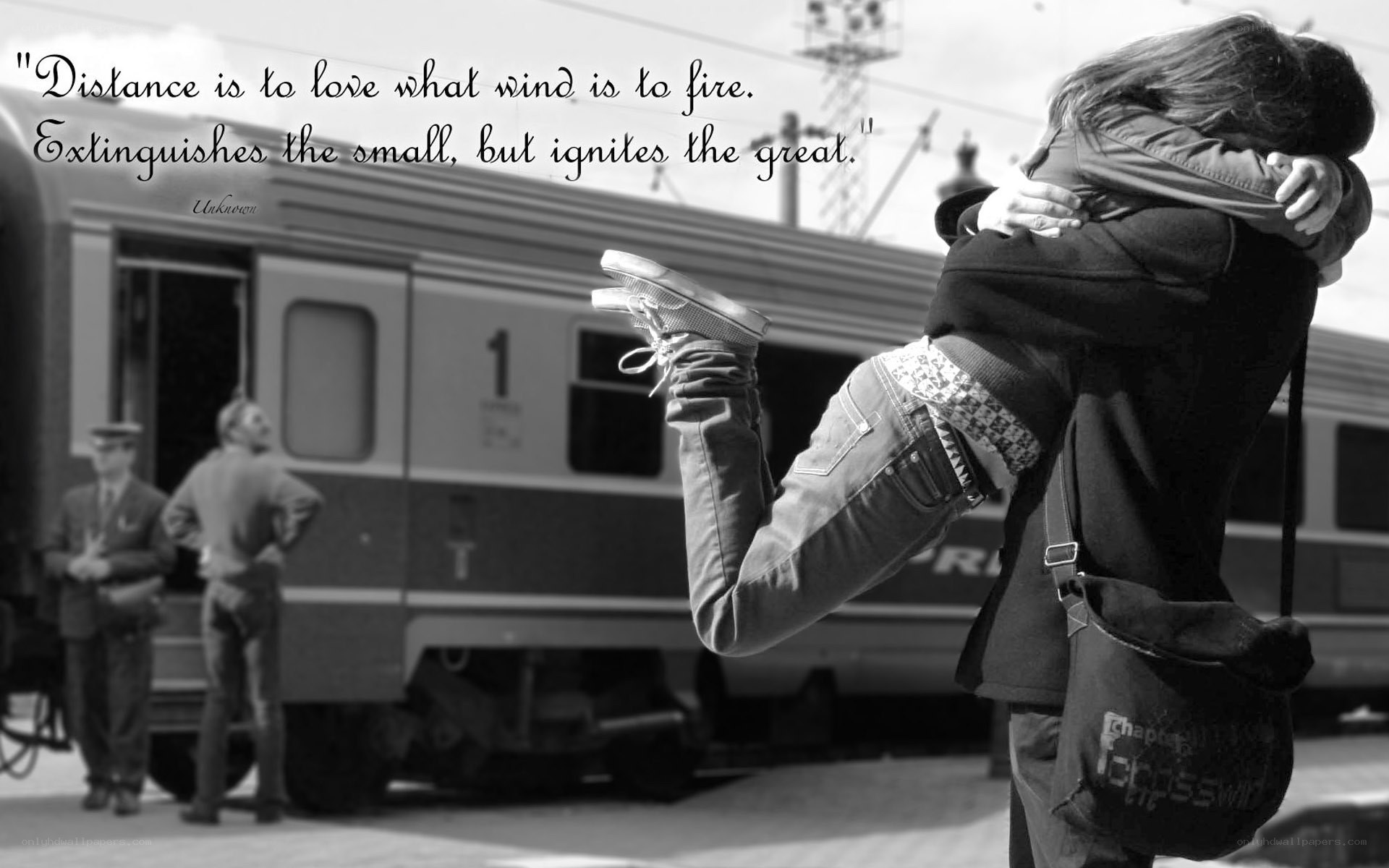 Couple hugging at train station