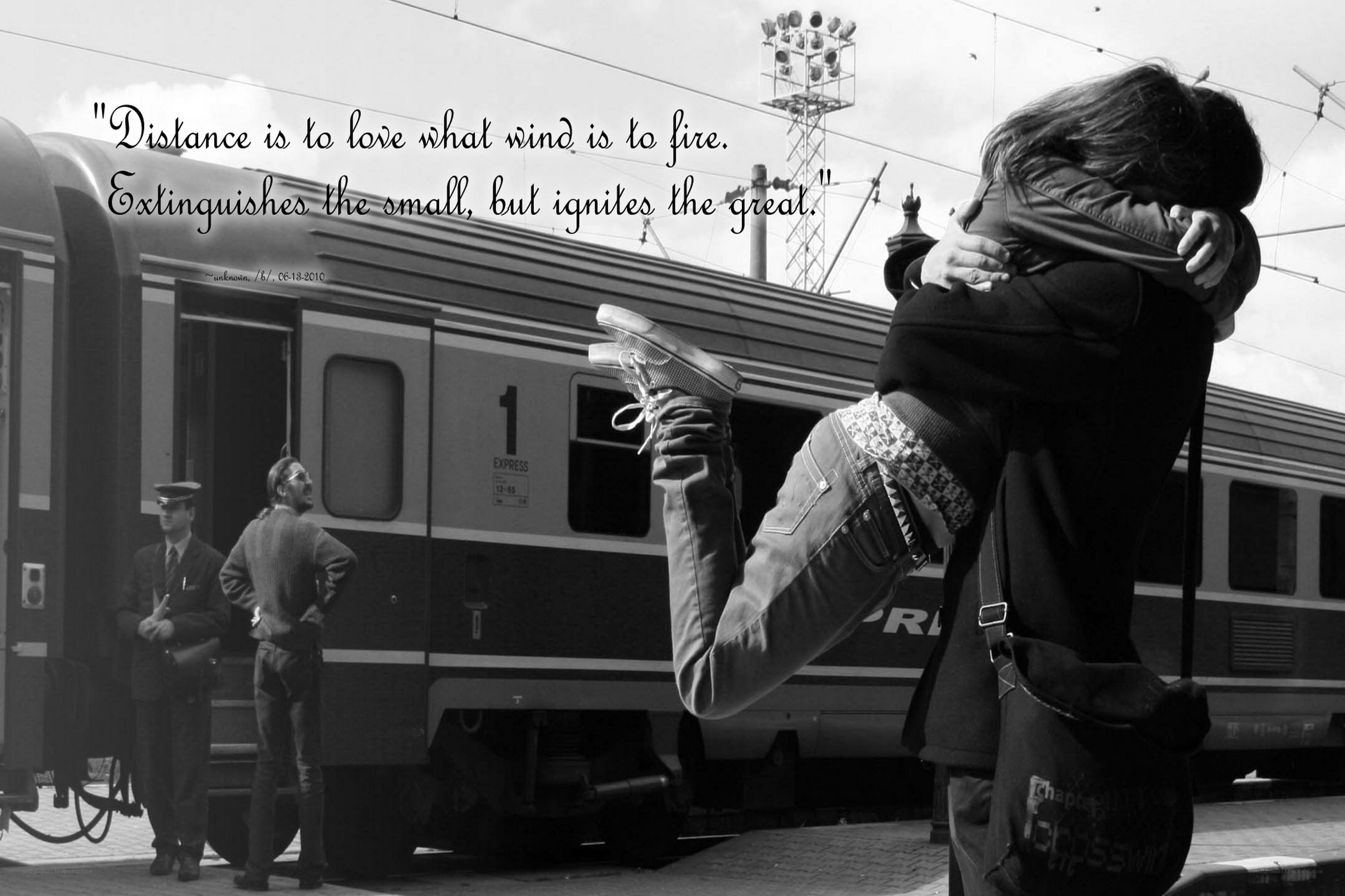 Couple hugging at train station