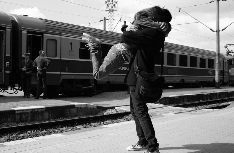 Couple Hugging at Train Station — Black, Dramatic