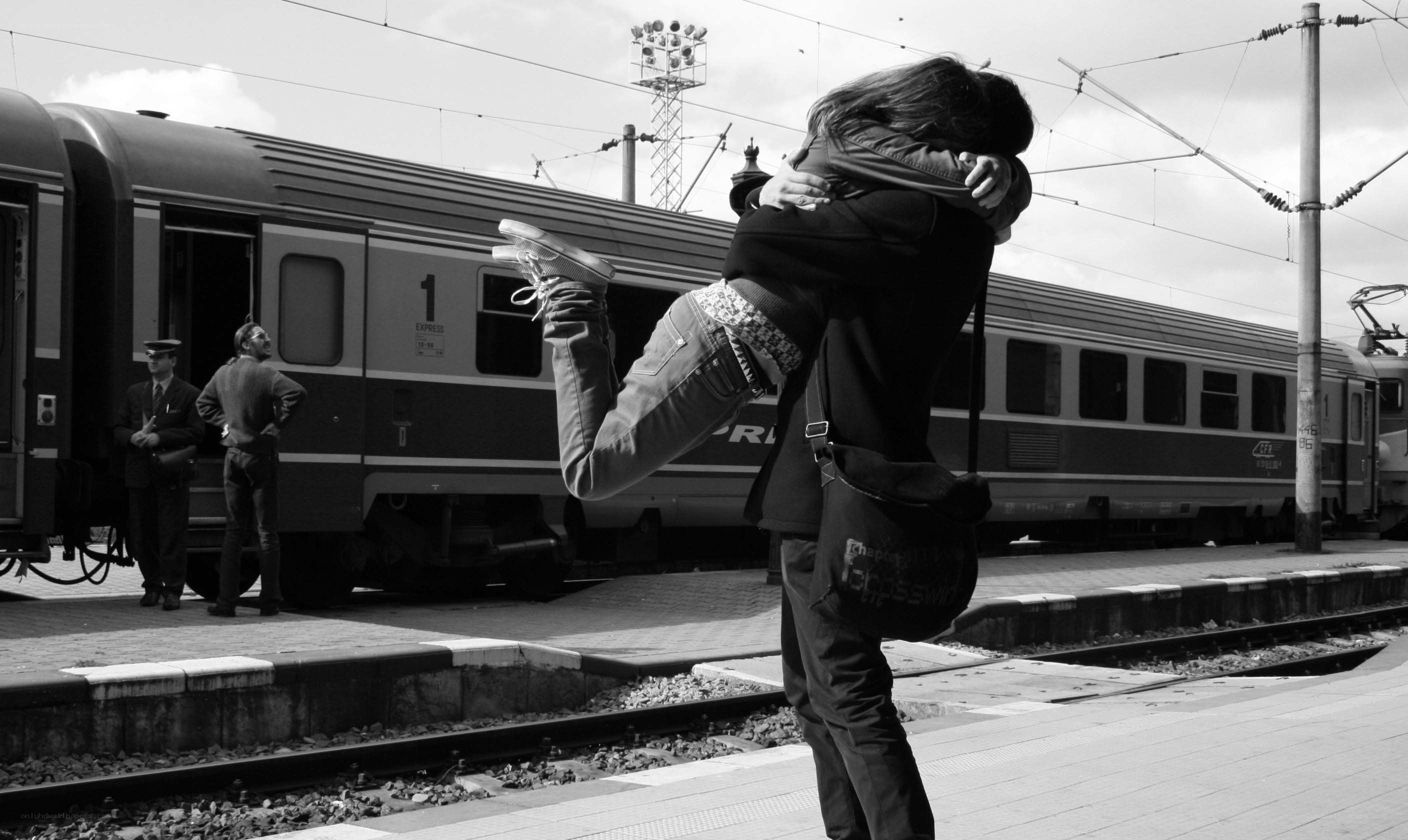 Couple hugging at train station