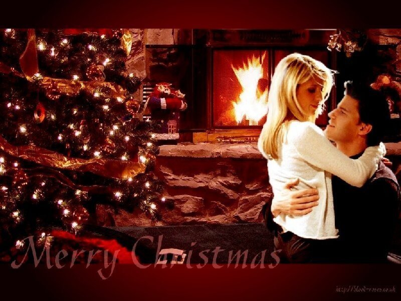 Couple Hugging by Fireplace