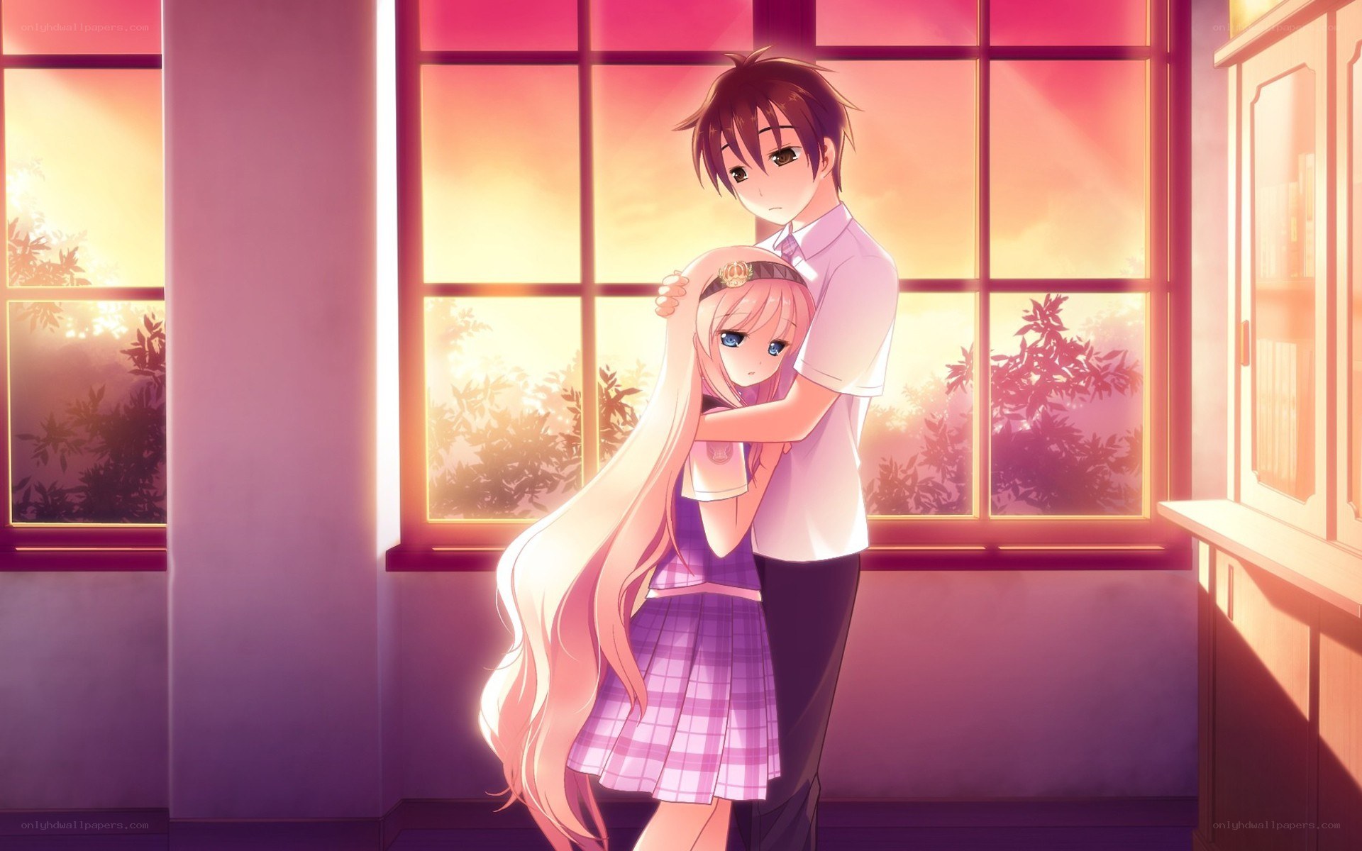 couple hugging by window