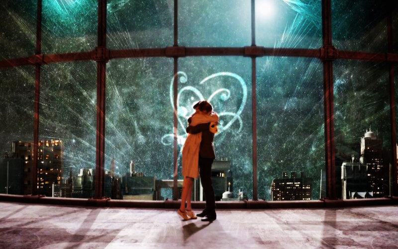 couple hugging by window