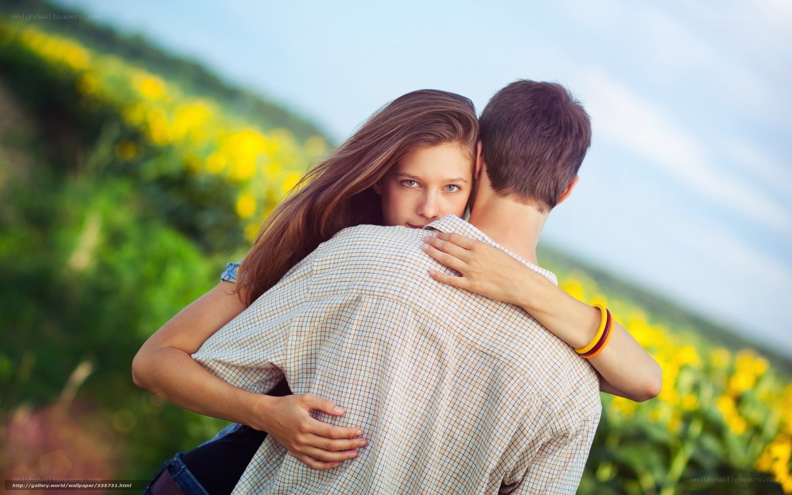 Couple hugging in a field